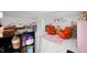 This bonus room features orange chairs, pink rugs, books and white floors at 3360 Main St, Plainfield, IN 46168