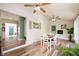 Cozy dining area with a fireplace, white chairs, and hardwood floors at 3360 Main St, Plainfield, IN 46168