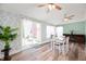 Bright dining area featuring a sliding glass door, modern wallpaper, and a view of the backyard at 3360 Main St, Plainfield, IN 46168