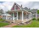 Inviting front porch features decorative columns, brick walkway, and flower baskets at 3360 Main St, Plainfield, IN 46168