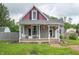 Charming home features a welcoming front porch with decorative columns and hanging flower baskets at 3360 Main St, Plainfield, IN 46168