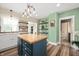 Stylish kitchen with a butcher block island, open shelving, and a view into the dining area at 3360 Main St, Plainfield, IN 46168