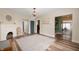 Open-concept living room with hardwood flooring, fireplace, and plenty of natural light at 3360 Main St, Plainfield, IN 46168