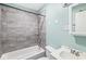 This bathroom features tile surround, shower head and a white vanity with chrome faucet at 3409 S Rural St, Indianapolis, IN 46237