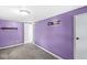 Inviting bedroom featuring bold purple walls, plush carpet, and ambient lighting at 3409 S Rural St, Indianapolis, IN 46237