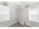 Simple bedroom featuring two windows, a mini-fridge, and neutral-tone walls at 3409 S Rural St, Indianapolis, IN 46237