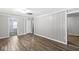 Neutral bedroom with updated wood-look flooring and access to other rooms at 3409 S Rural St, Indianapolis, IN 46237