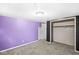 Bedroom showcasing gray carpet, closet, and purple and black walls at 3409 S Rural St, Indianapolis, IN 46237