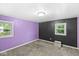 Cozy bedroom featuring two windows, plush gray carpet and purple and black accent walls at 3409 S Rural St, Indianapolis, IN 46237