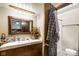 Traditional bathroom vanity features a marble countertop, dark wood cabinets, and decorative accents at 3480 W Broadus Dr, North Vernon, IN 47265