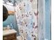 A stylish bathroom with a tiled shower, a patterned shower curtain, and modern fixtures at 3480 W Broadus Dr, North Vernon, IN 47265