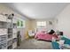 A cozy bedroom features a pink bed, a white chair, and ample storage with cube shelving at 3480 W Broadus Dr, North Vernon, IN 47265