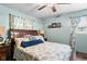 The blue-themed bedroom boasts a large bed with decorative pillows and natural light at 3480 W Broadus Dr, North Vernon, IN 47265