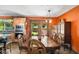 Open dining area featuring unique wood table, vintage chairs, and natural light at 3480 W Broadus Dr, North Vernon, IN 47265