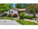 Charming ranch home entrance with stone facade, colorful landscaping, and walkway at 3480 W Broadus Dr, North Vernon, IN 47265