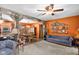 Inviting living room with rustic beams, orange accent wall, and comfortable blue seating at 3480 W Broadus Dr, North Vernon, IN 47265