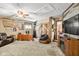 A spacious office features a ceiling fan, a large wooden desk, and a comfortable armchair at 3480 W Broadus Dr, North Vernon, IN 47265