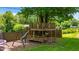 Backyard treehouse and playground with slide, swing, and green lawn at 3480 W Broadus Dr, North Vernon, IN 47265