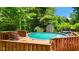 Backyard pool with deck and wooded surround at 3480 W Broadus Dr, North Vernon, IN 47265