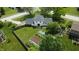 Aerial view of a home featuring a large backyard, garden area, patio, and surrounding trees at 377 4Th E Ct, Carmel, IN 46033