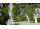 Aerial view of a landscaped home with a driveway and mature trees at 377 4Th E Ct, Carmel, IN 46033