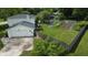 Aerial perspective of home with large yard including a garden, surrounded by lush greenery and mature trees at 377 4Th E Ct, Carmel, IN 46033