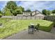 Backyard with a well-maintained lawn, a stone patio with outdoor seating, and a wooden fence for privacy at 377 4Th E Ct, Carmel, IN 46033
