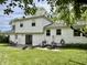 Backyard view with a patio set, chairs, and well-maintained grass at 377 4Th E Ct, Carmel, IN 46033