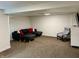 Cozy basement featuring neutral carpet, comfortable seating, and a TV, perfect for relaxation and entertainment at 377 4Th E Ct, Carmel, IN 46033