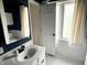 Bright bathroom featuring a white vanity, subway tile, and a window providing natural light at 377 4Th E Ct, Carmel, IN 46033
