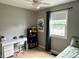 Bedroom featuring neutral gray walls, a window, and a desk for work or play at 377 4Th E Ct, Carmel, IN 46033