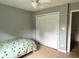Bedroom with a twin bed and a closet, featuring light-colored wood floors at 377 4Th E Ct, Carmel, IN 46033