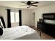Comfortable bedroom featuring a metal bed frame, wood floors, ceiling fan, and ample natural light at 377 4Th E Ct, Carmel, IN 46033