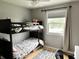 Bedroom with a bunk bed, window, and wood floors, perfect for  at 377 4Th E Ct, Carmel, IN 46033