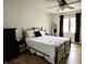 Charming bedroom featuring a metal bed frame, wood floors, ceiling fan, and ample natural light at 377 4Th E Ct, Carmel, IN 46033