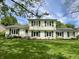 Charming two-story home with a light blue door and lush green lawn at 377 4Th E Ct, Carmel, IN 46033