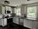 Bright kitchen with white cabinets, stainless steel appliances and natural lighting at 377 4Th E Ct, Carmel, IN 46033