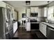 Bright kitchen with stainless steel appliances and view into the living room and dining room at 377 4Th E Ct, Carmel, IN 46033