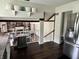 View of the transition from the kitchen to the living room, which features built-in shelving and a fireplace at 377 4Th E Ct, Carmel, IN 46033