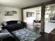 View of living room featuring sofas, decorative rug, and open access to dining area at 377 4Th E Ct, Carmel, IN 46033