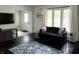 Cozy living room area with natural light, front door and mounted TV at 377 4Th E Ct, Carmel, IN 46033