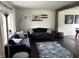 Living room view featuring sofas, side tables, decorative lighting, and accent rug at 377 4Th E Ct, Carmel, IN 46033