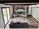 Bright living room with hardwood floors, exposed beams, fireplace with built-ins, and sliding doors to the outdoors at 377 4Th E Ct, Carmel, IN 46033