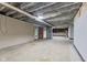 Spacious basement features exposed beams, painted walls, and concrete flooring at 3841 S Sherman Dr, Indianapolis, IN 46237