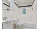 Bright bathroom with a white tub, decorative tiles, and modern fixtures at 3841 S Sherman Dr, Indianapolis, IN 46237