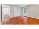Cozy bedroom with wood-look flooring, a closet, and natural light from the window at 3841 S Sherman Dr, Indianapolis, IN 46237