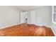 The bedroom has wood-look flooring, neutral paint, and an open doorway to another room at 3841 S Sherman Dr, Indianapolis, IN 46237