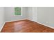 This bedroom is brightly lit with a large window and beautiful hardwood floors at 3841 S Sherman Dr, Indianapolis, IN 46237