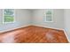 Bright bedroom features wood-look flooring and natural light from two windows at 3841 S Sherman Dr, Indianapolis, IN 46237