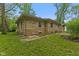Stone exterior and well-maintained lawn surround this charming single story home at 3841 S Sherman Dr, Indianapolis, IN 46237
